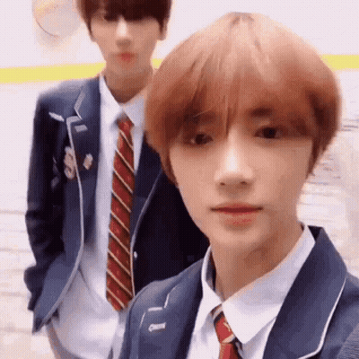 Two Men In Suits And Ties Standing Together GIF
