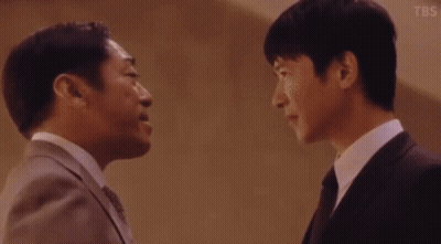 Two Men In Suits And Ties Talking GIF