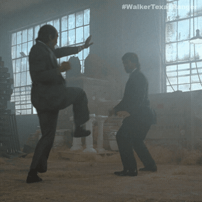 Two Men In Suits Are Dancing In A Dark Room With The Hashtag #Walkertexasrangers GIF