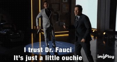 Two Men In Suits Are Dancing With The Words I Trust Dr. Fauci It 'S Just A Little Ouchie Below Them GIF