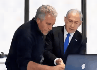 two men in suits are looking at a laptop computer .