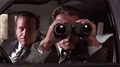 Two Men In Suits Are Looking Through Binoculars In A Car . GIF
