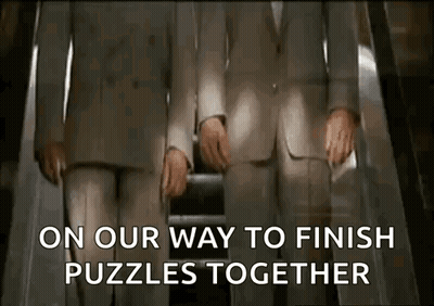 Two Men In Suits Are Riding An Escalator And The Words On Our Way To Finish Puzzles Together Are Displayed GIF
