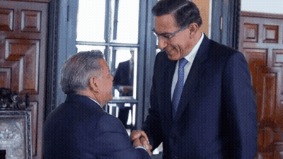 Two Men In Suits Are Shaking Hands And Smiling GIF