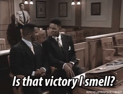 Two Men In Suits Are Sitting In A Courtroom With The Caption Is That Victory I Smell ? GIF