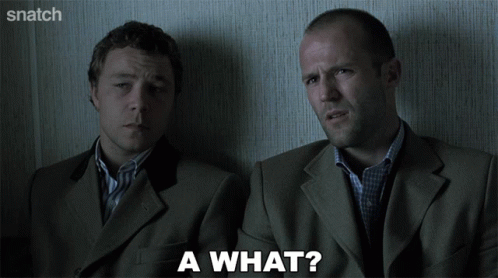 Two Men In Suits Are Sitting Next To Each Other And One Of Them Is Asking A What GIF