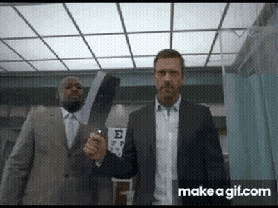 Two Men In Suits Are Standing Next To Each Other Holding A Large X-Ray . GIF