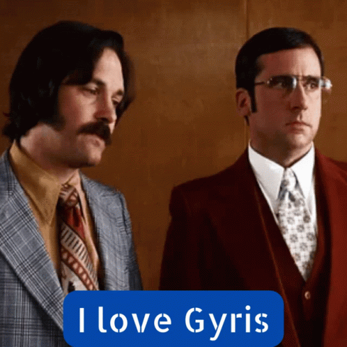 Two Men In Suits Are Standing Next To Each Other With A Blue Sign That Says I Love Gyris GIF