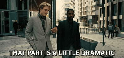 Two Men In Suits Are Walking Down A Street With The Words That Part Is A Little Dramatic Below Them GIF