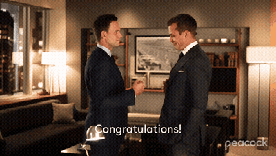 Two Men In Suits Congratulating Each Other With Peacock GIF