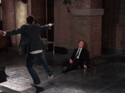 Two Men In Suits Jumping And Sitting GIF