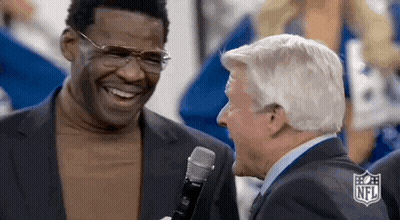 Two Men In Suits Laughing Into Microphone GIF