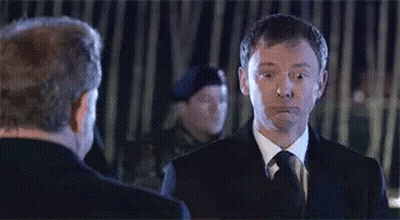 Two Men In Suits Looking At Each Other GIF