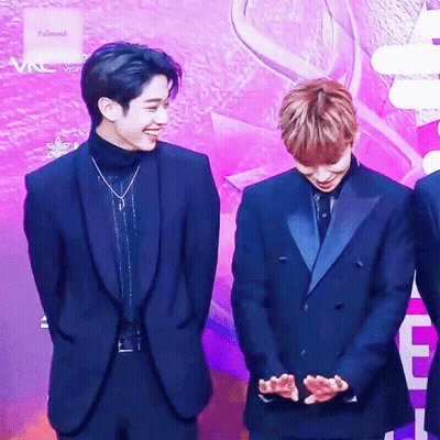 Two Men In Suits On Purple Carpet GIF