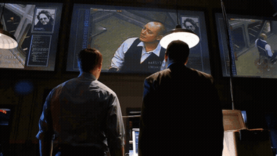 Two Men In Suits One Wearing James Name Tag GIF