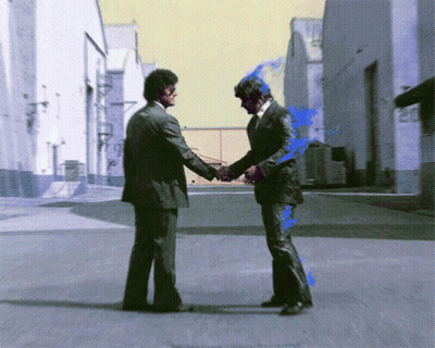 Two Men In Suits Shake Hands On A Street GIF