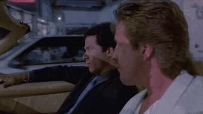 Two Men In Suits Sitting In Car Talking GIF