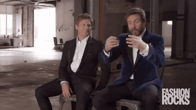 Two Men In Suits Sitting With Fashion Rocks GIF