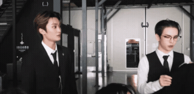 Two Men In Suits Standing GIF