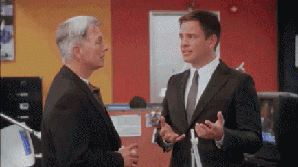 Two Men In Suits Standing GIF