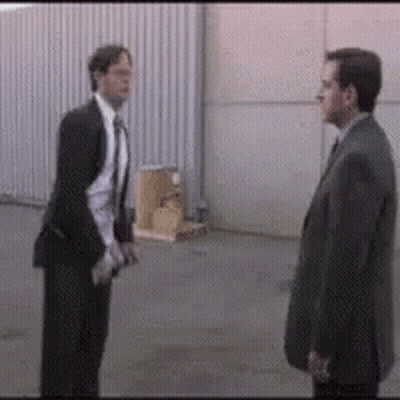 Two Men In Suits Standing Together GIF
