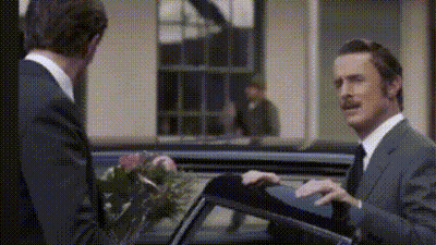 Two Men In Suits Standing Together GIF