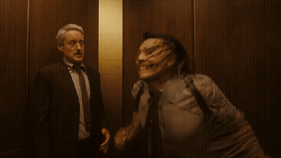 Two Men In Suits Standing Together GIF