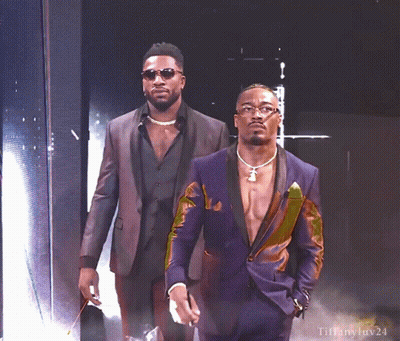 Two Men In Suits Standing Together GIF