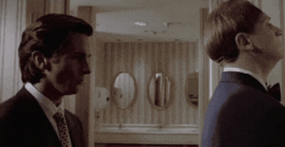 Two Men In Suits Standing Together GIF