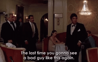 Two Men In Suits Standing Together GIF
