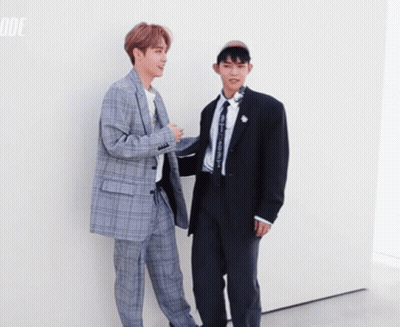 Two Men In Suits Standing Together GIF