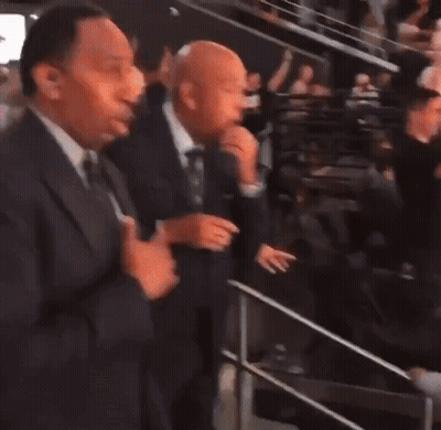 Two Men In Suits Standing Together GIF