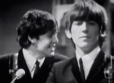 Two Men In Suits Talking Into Microphones GIF