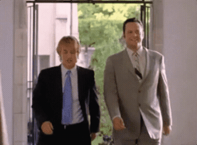 Two Men In Suits Walking In Room GIF