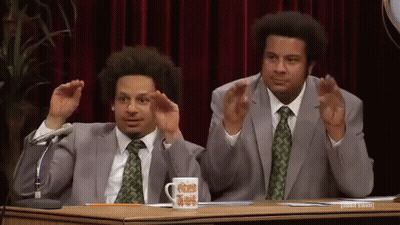 Two Men In Suits With Microphone And Mug GIF