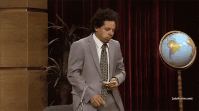 Two Men In Suits With Microphone And Mug GIF