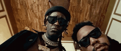 Two Men In Sunglasses And Hats Posing GIF