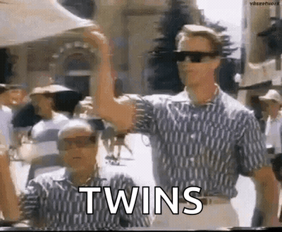 Two Men In Sunglasses Beside Each Other Arms Raised GIF