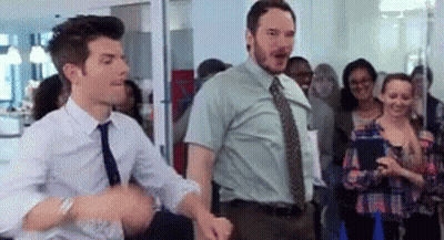 Two Men In Ties Are Dancing In Front Of A Crowd Of People . GIF