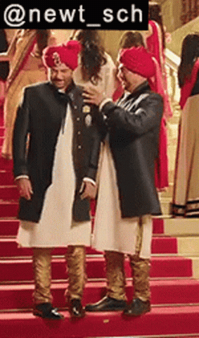 Two Men In Turbans Standing On Stairs GIF