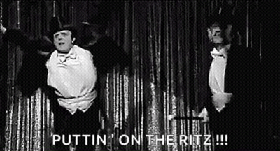 Two Men In Tuxedos Dancing On Stage GIF