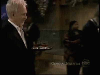 Two Men In Tuxedos Holding Glasses Of Wine GIF