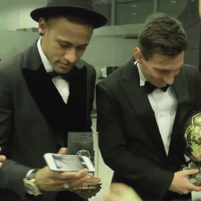 Two Men In Tuxedos Looking At Cell Phone GIF