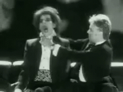 Two Men In Tuxedos Talking GIF