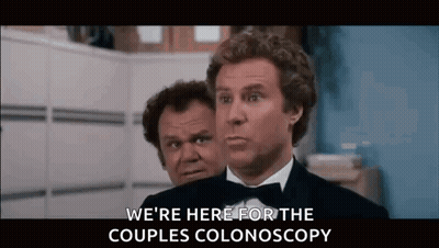 Two Men In Tuxedos Talking About Colonoscopy GIF