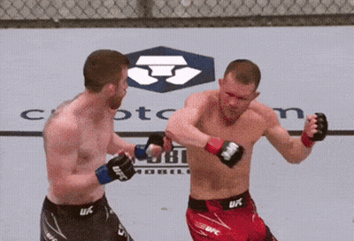 Two Men In UFC Shorts Fighting In Front Of Crypto.com Logo GIF