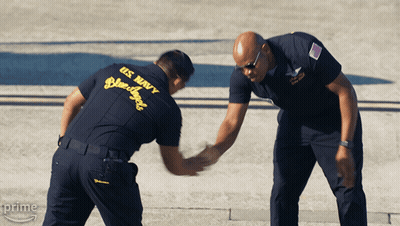 Two Men In Us Navy Uniforms Shake Hands With Each Other GIF