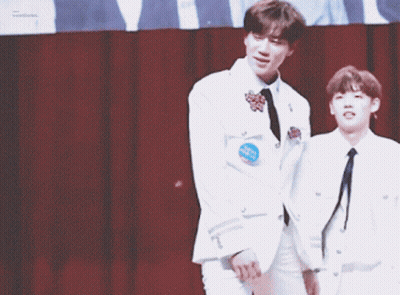 Two Men In White Jackets Holding Hands And Smiling GIF