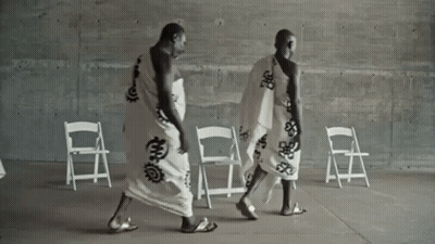 Two Men In White Robes Walking GIF