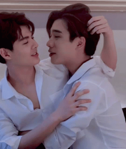 Two Men In White Shirts Hugging And Scratching Hair GIF